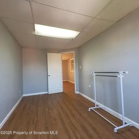 a view of a room with wooden floor