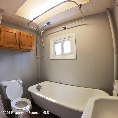 a bathroom with a toilet sink and bathtub