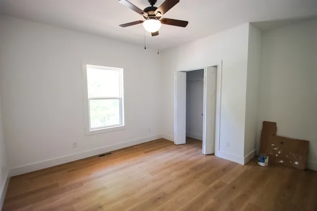 wooden floor in an empty room with a window