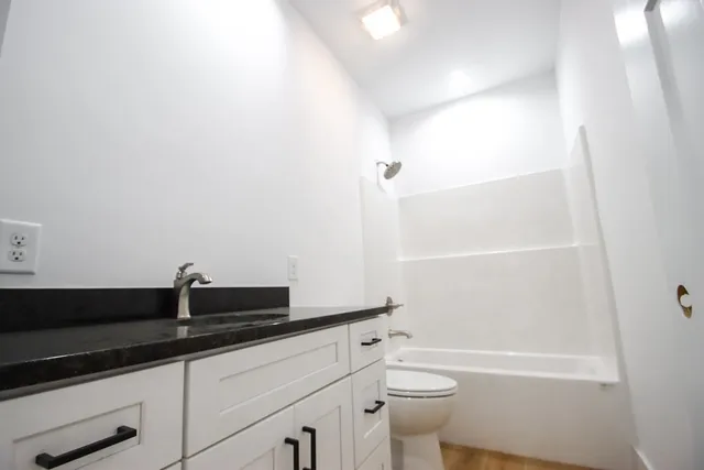 a bathroom with a bathtub and a toilet