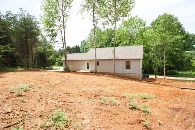 a backyard of a house with large trees