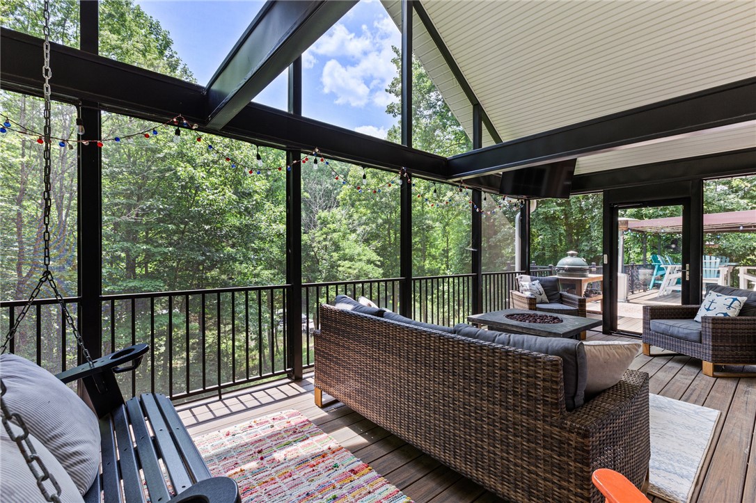 322 Shorecrest Drive Seneca, SC 29672 - Photo 22 of 30 This screened-in porch offers tranquil views of lush greenery, perfect for relaxation and outdoor gatherings.