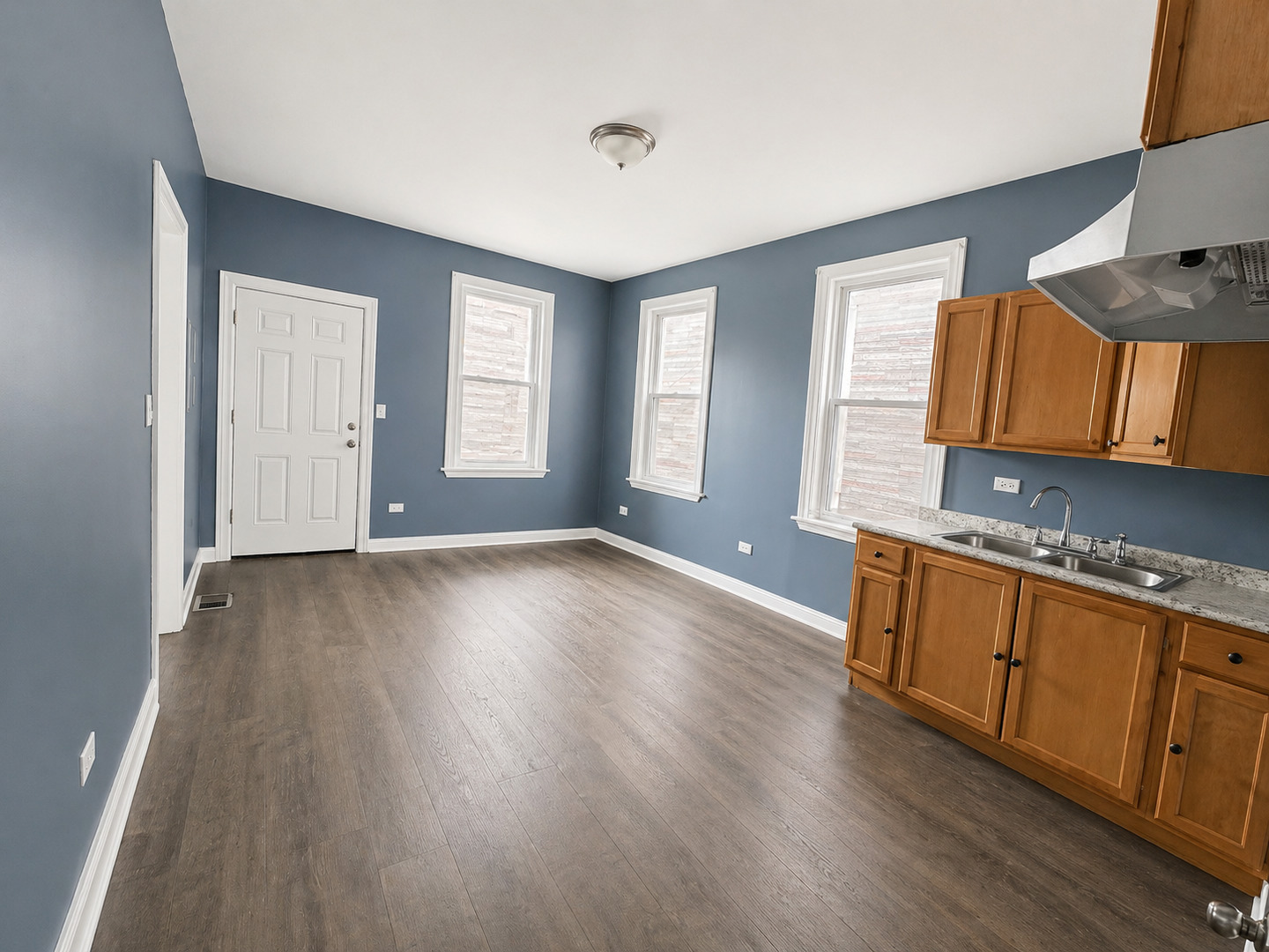 2114 West 51st Street, Unit 1 Chicago, IL 60609 - Photo 4 of 9 a view of a kitchen with wooden floor and electronic appliances