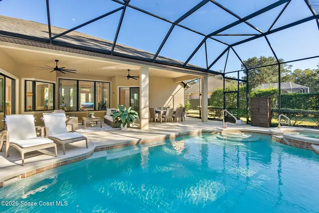 a view of a patio with dining table and chairs under an umbrella
