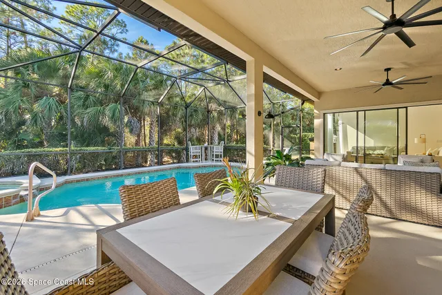 a view of a patio with a table chairs and a tub