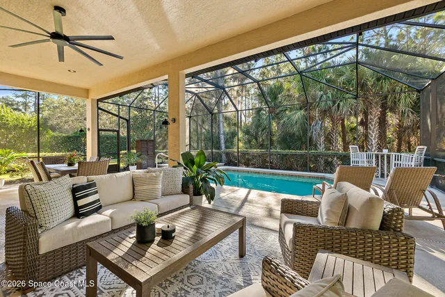 a living room with furniture and a floor to ceiling window