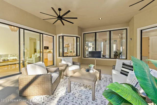 a living room with furniture and large windows