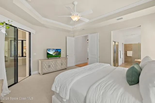 a bedroom with a large bed and a flat screen tv