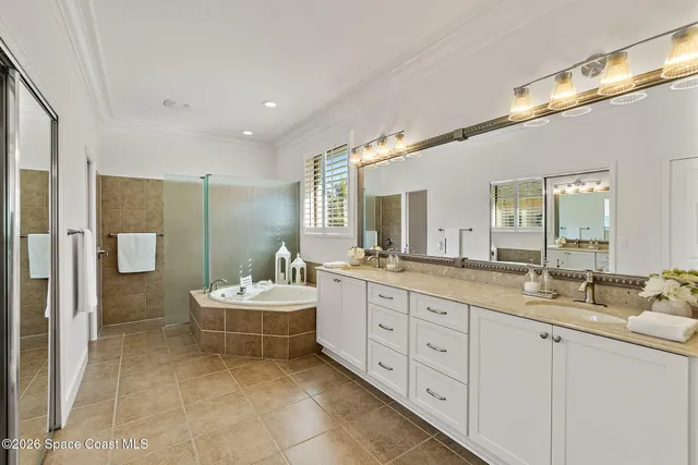a spacious bathroom with a double vanity sink mirror and double