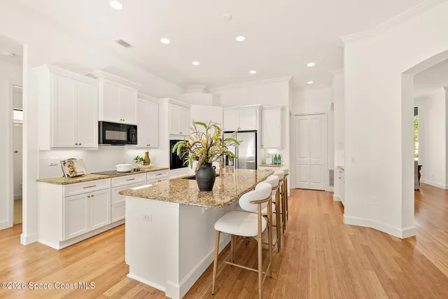 a living room with furniture white walls and glass table