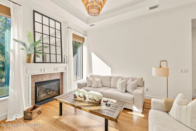 a living room with furniture large window and fireplace