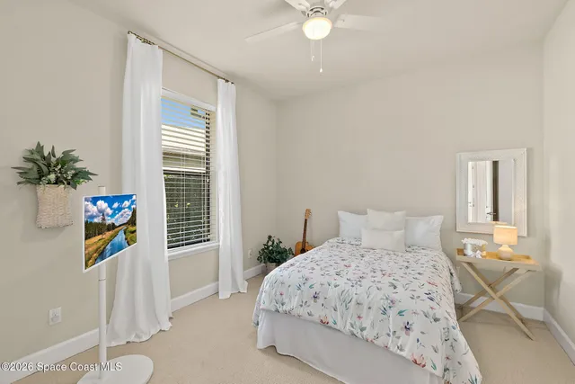 a bedroom with a bed and windows