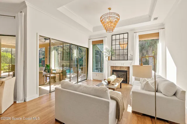 a living room with furniture a fireplace and a large window