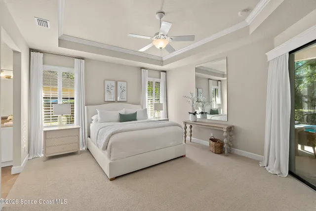 a spacious bedroom with a bed and large window