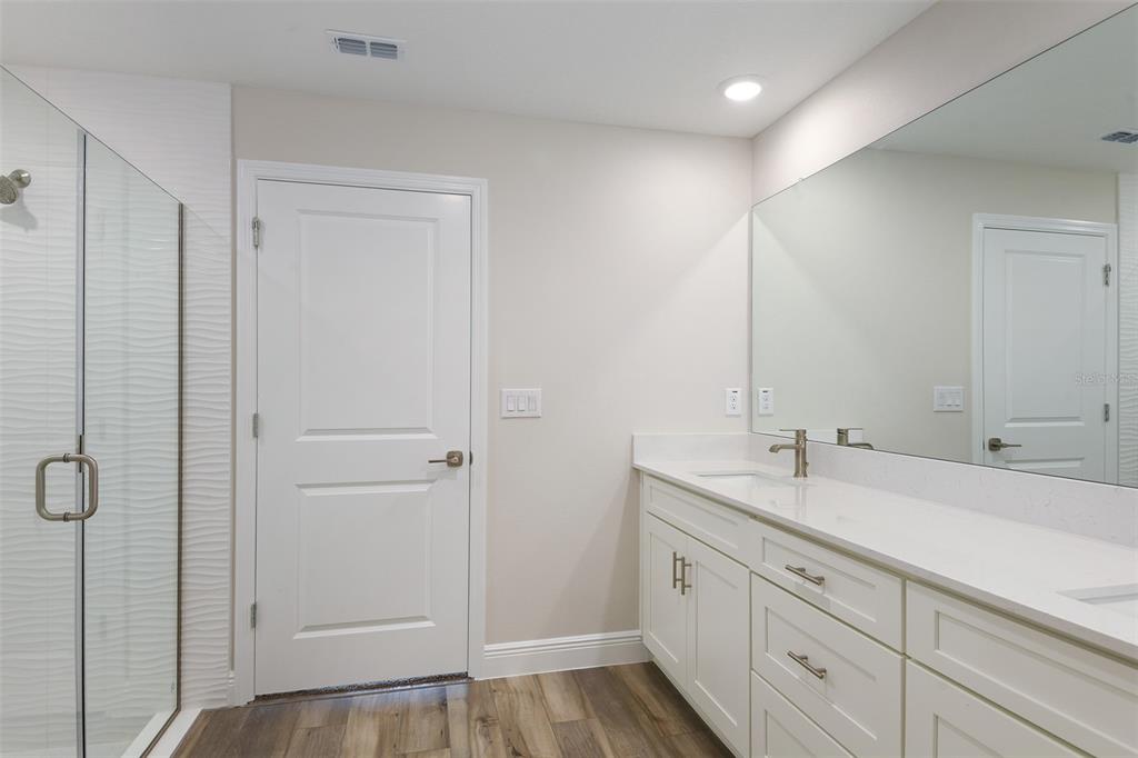 6103 Southwest 97th Street Ocala, FL 34476 - Photo 6 of 26 a spacious bathroom with a shower sink and mirror