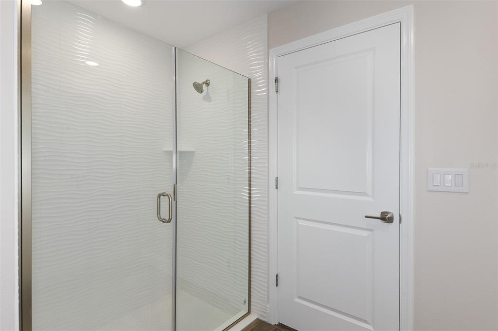6103 Southwest 97th Street Ocala, FL 34476 - Photo 8 of 26 a bathroom with a shower and a glass door