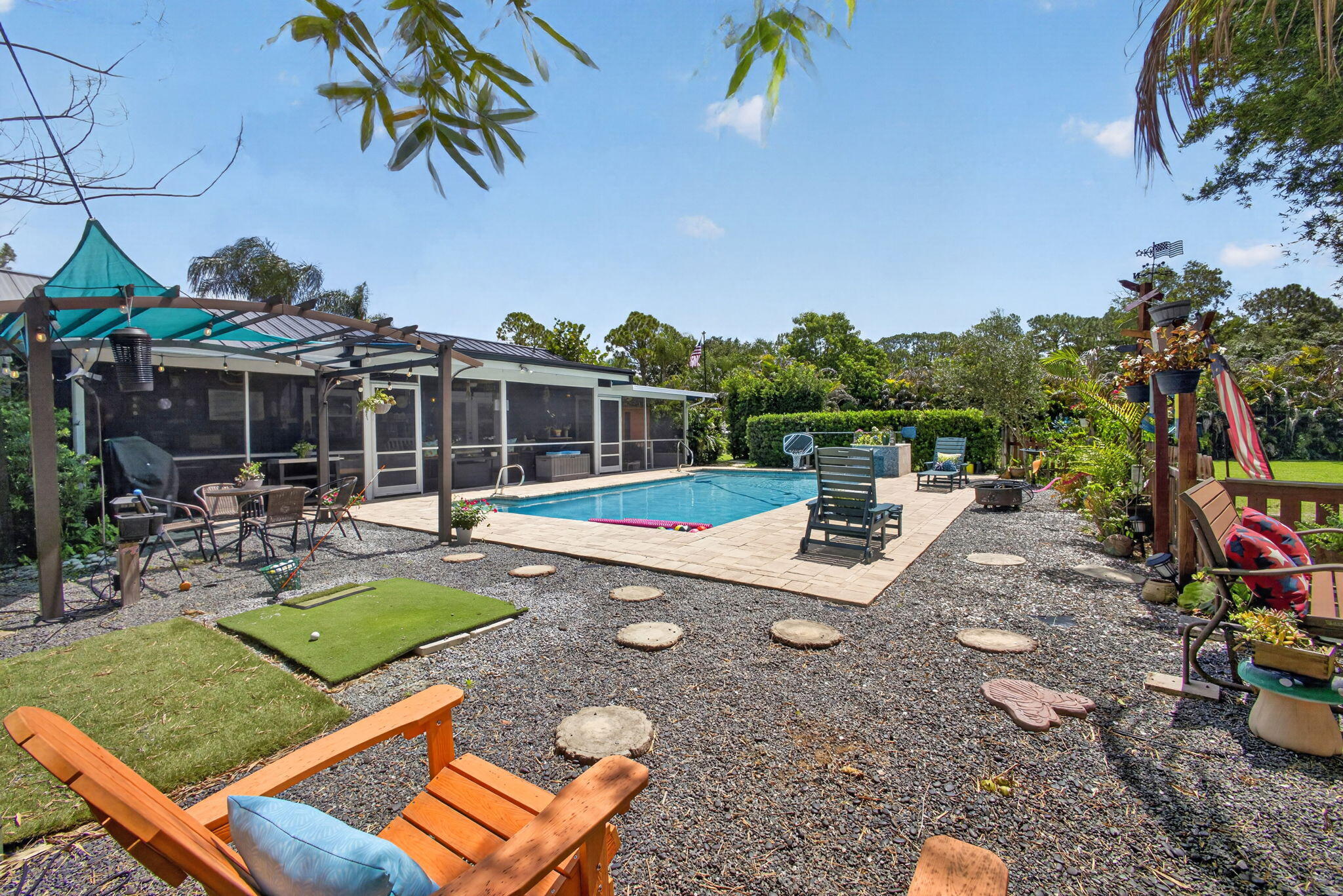 12558 165th Road North Jupiter, FL 33478 - Photo 43 of 67 a view of a backyard with plants and patio