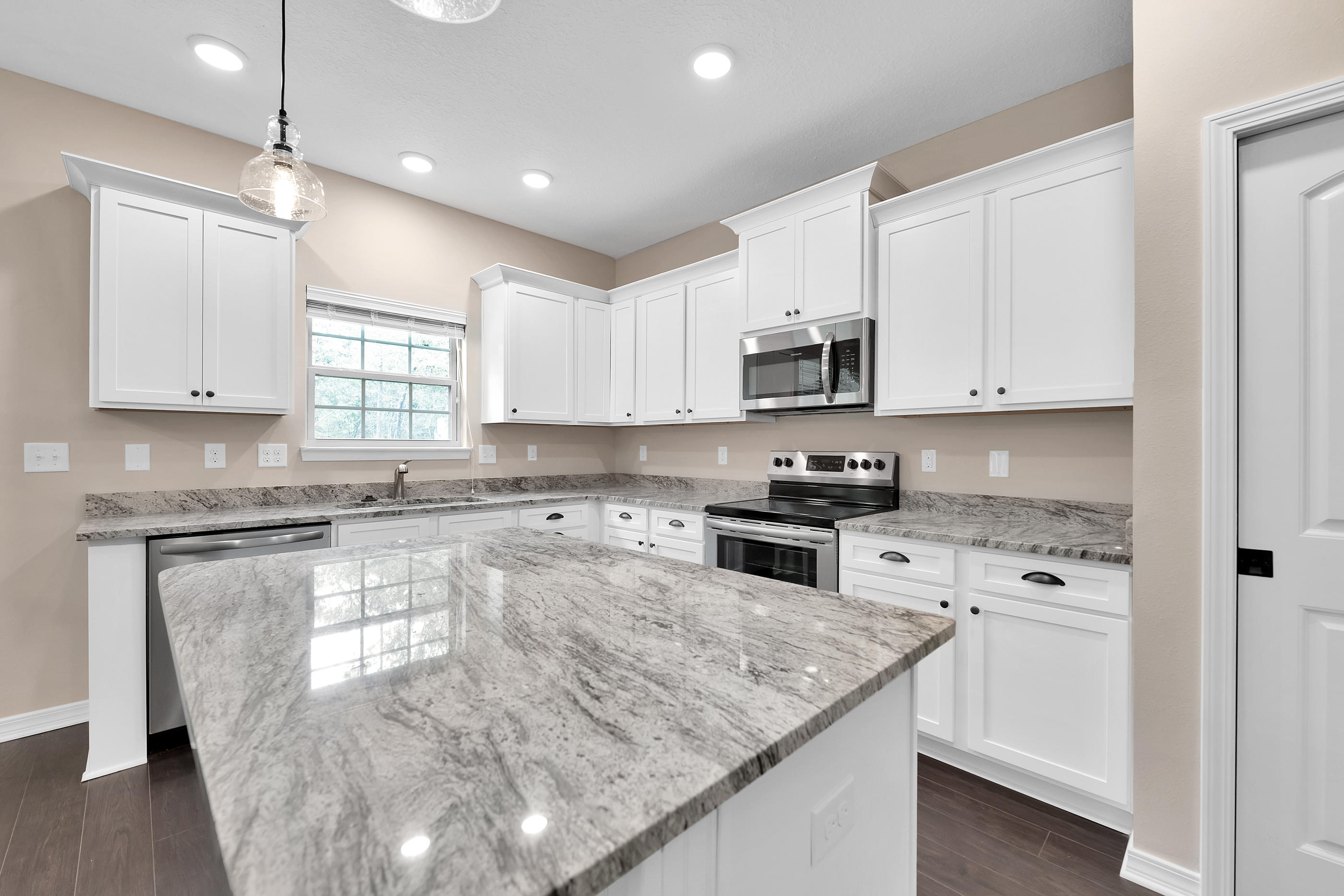 6198 Timberland Ridge Drive Crestview, FL 32539 - Photo 15 of 37 a kitchen with granite countertop white cabinets and white appliances