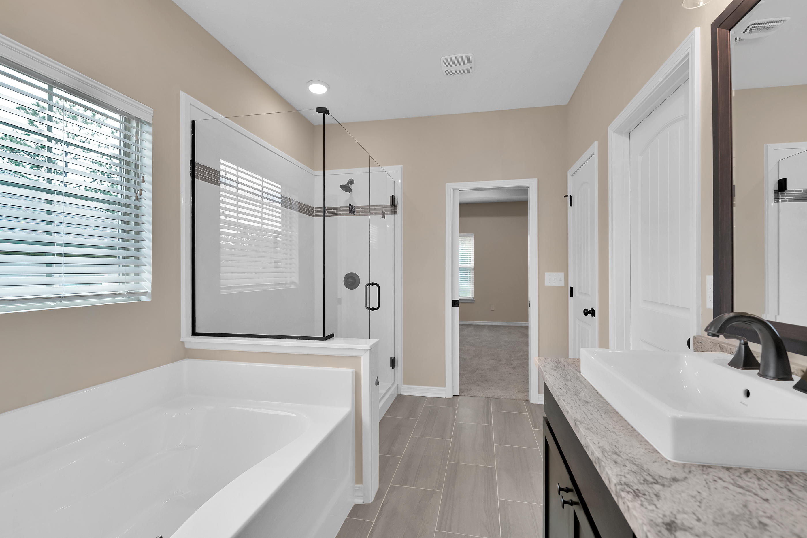 6198 Timberland Ridge Drive Crestview, FL 32539 - Photo 31 of 37 a bathroom with a granite countertop tub sink a mirror and a shower