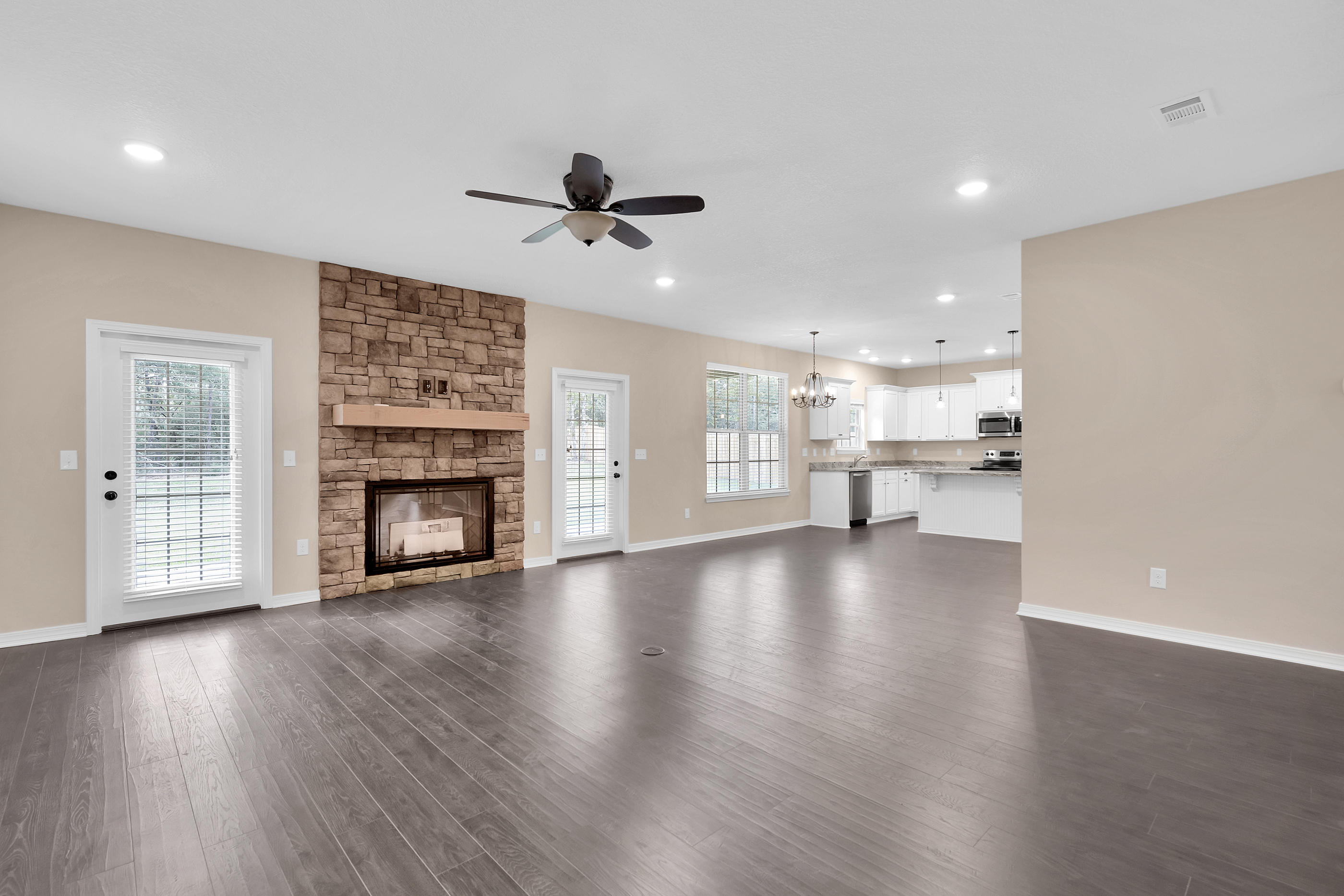 6198 Timberland Ridge Drive Crestview, FL 32539 - Photo 10 of 37 a view of empty room with wooden floor and a fireplace