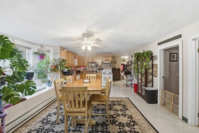 a bedroom with a bed a chandelier and dresser