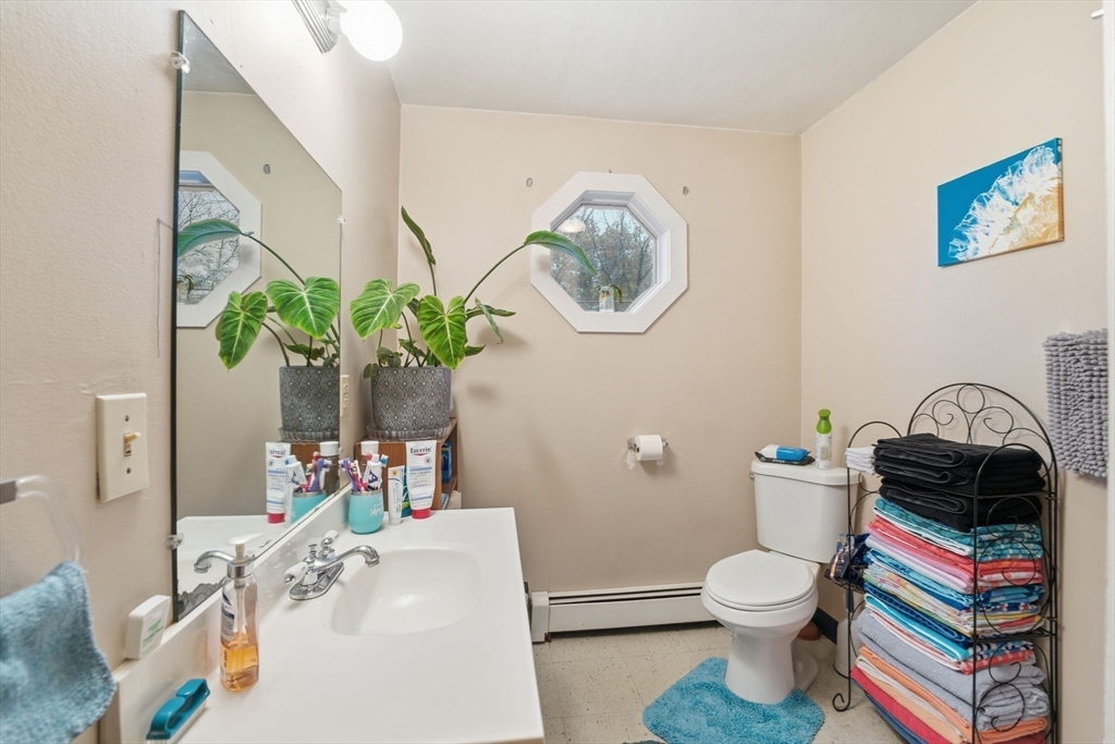 248-252 Church Street Burrillville, RI 02859 - Photo 20 of 26 a bathroom with a toilet a sink and a mirror