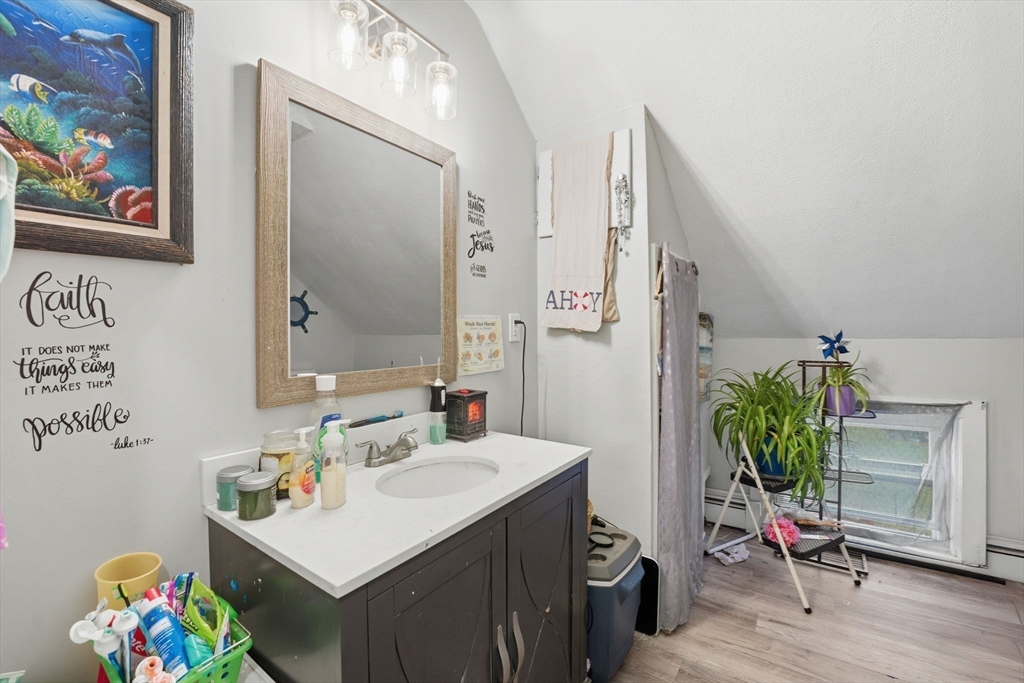 248-252 Church Street Burrillville, RI 02859 - Photo 22 of 26 a bathroom with a sink mirror and vanity