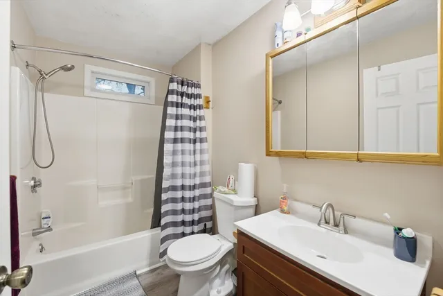 a bathroom with a toilet sink and shower