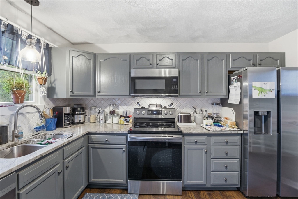 248-252 Church Street Burrillville, RI 02859 - Photo 9 of 26 a kitchen with a sink stove and cabinets