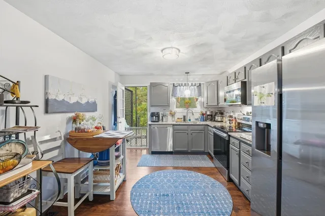 a kitchen with a sink appliances and cabinets