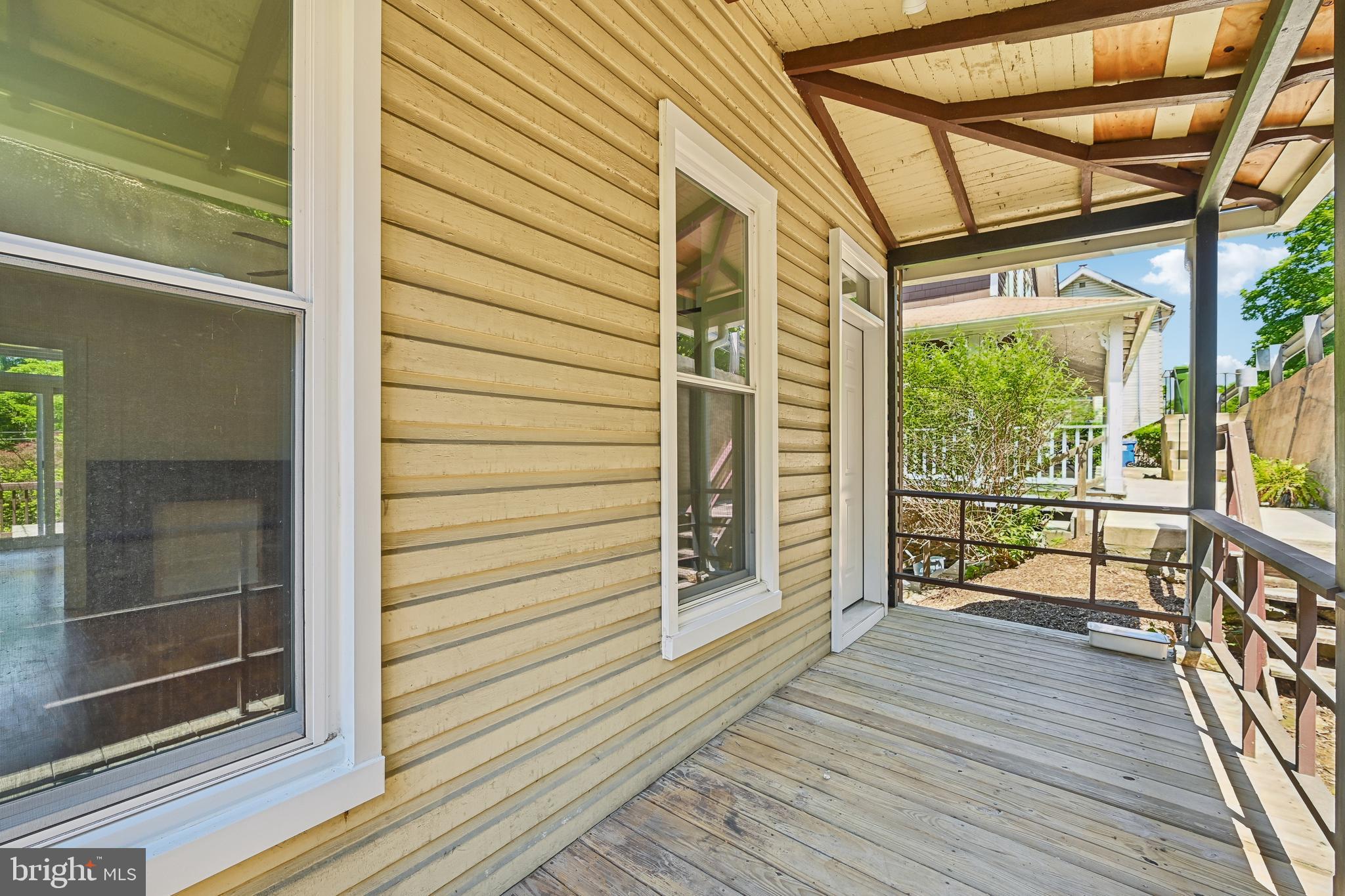 5702 Falls Road Baltimore, MD 21209 - Photo 48 of 49 a view of a porch with wooden floor and furniture