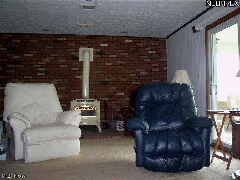 2006 Frost Road Streetsboro, OH 44241 - Photo 8 of 25 Step down to the Family Room with wood burning stove and access to the 3 Season Room