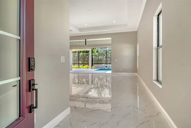 a large kitchen with stainless steel appliances a large counter top and a refrigerator