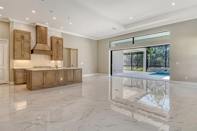 a view of a kitchen with a sink and a large window