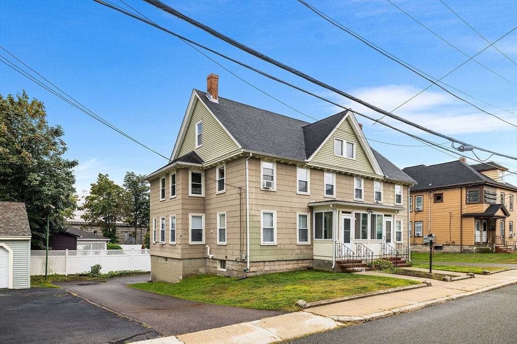 4 State Street, Unit 4 Milford, MA 01757 - Photo 2 of 23 a view of a white house with a big yard plants and large trees