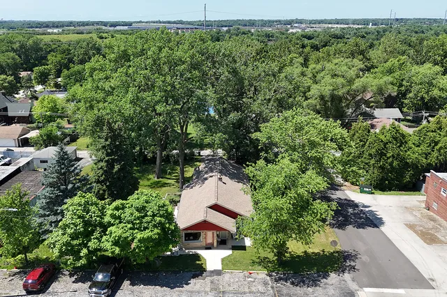 an aerial view of a house with a yard and lake view