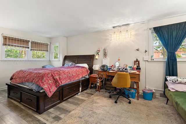 a bedroom with a bed a table and chair