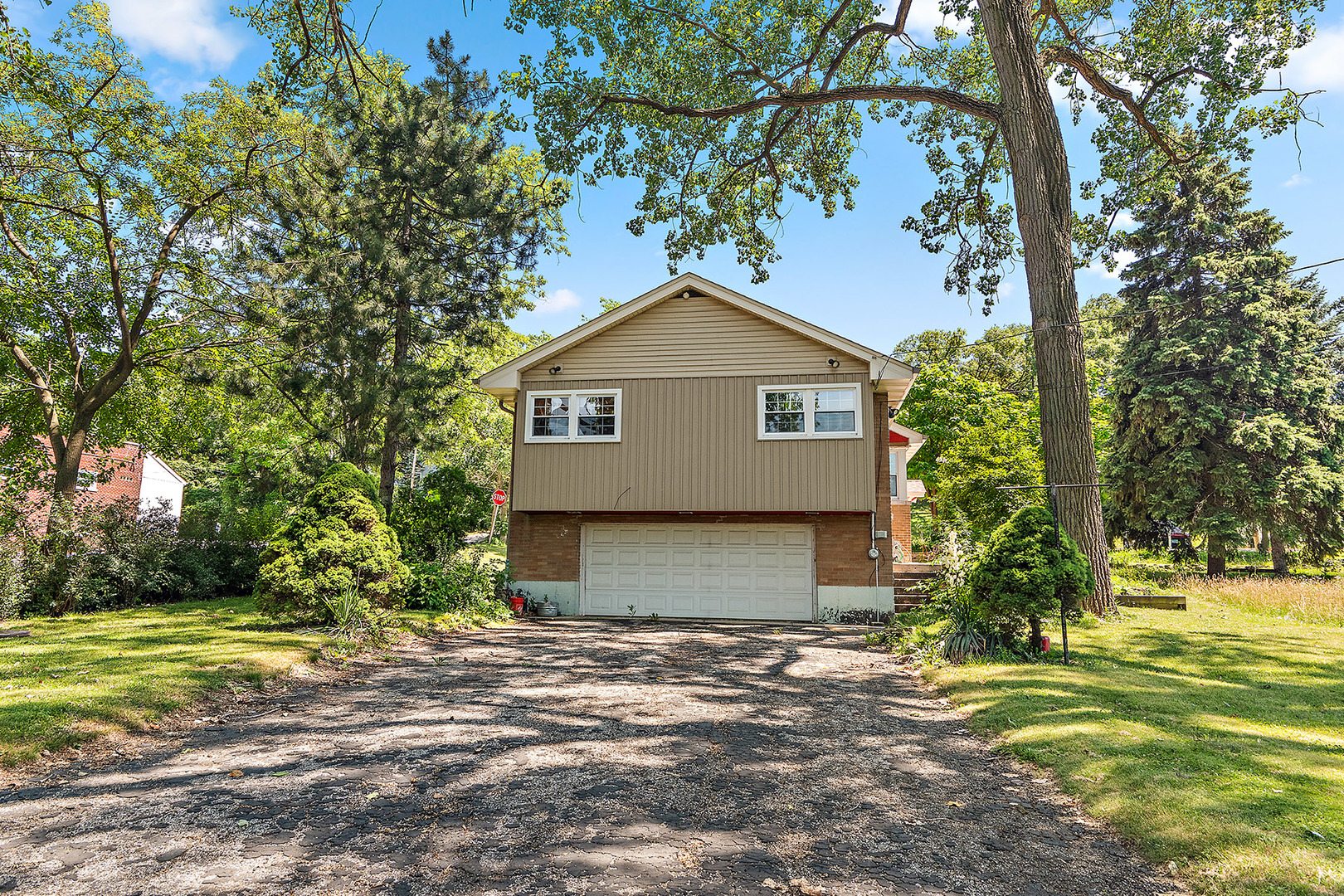 8420 Archer Avenue Willow Springs, IL 60480 - Photo 25 of 33 a view of a yard in front of a house with large trees