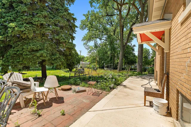 a view of backyard with outdoor seating and green space