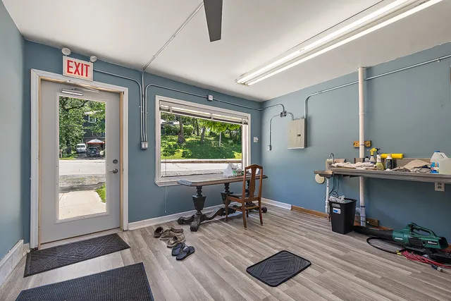 a view of a workspace with furniture and a window