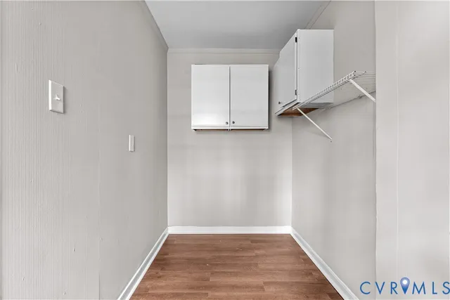 a view of a room with wooden floor and white wall