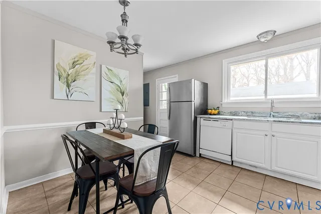 a kitchen with stainless steel appliances granite countertop a dining table chairs and a large window