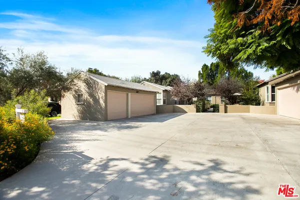 a view of garage with a house