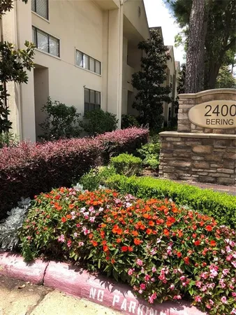 a view of a bunch of flowers in front of house
