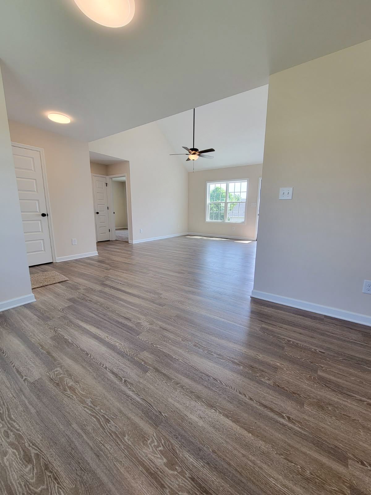 62 Modena Place Decherd, TN 37324 - Photo 14 of 31 an empty room with wooden floor and windows