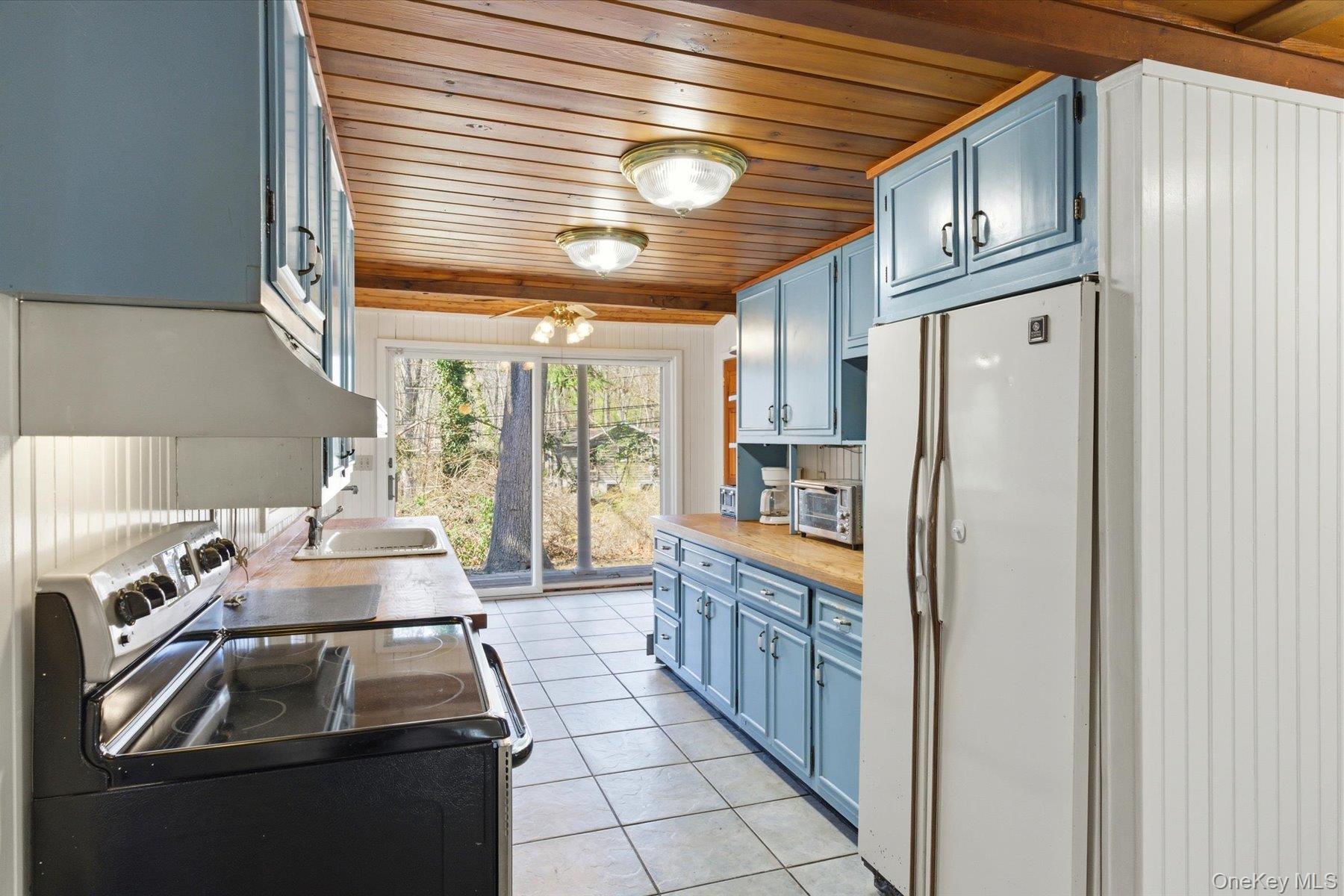 45 Eastwood Road Miller Place, NY 11764 - Photo 17 of 45 a kitchen with stainless steel appliances granite countertop a refrigerator and a stove