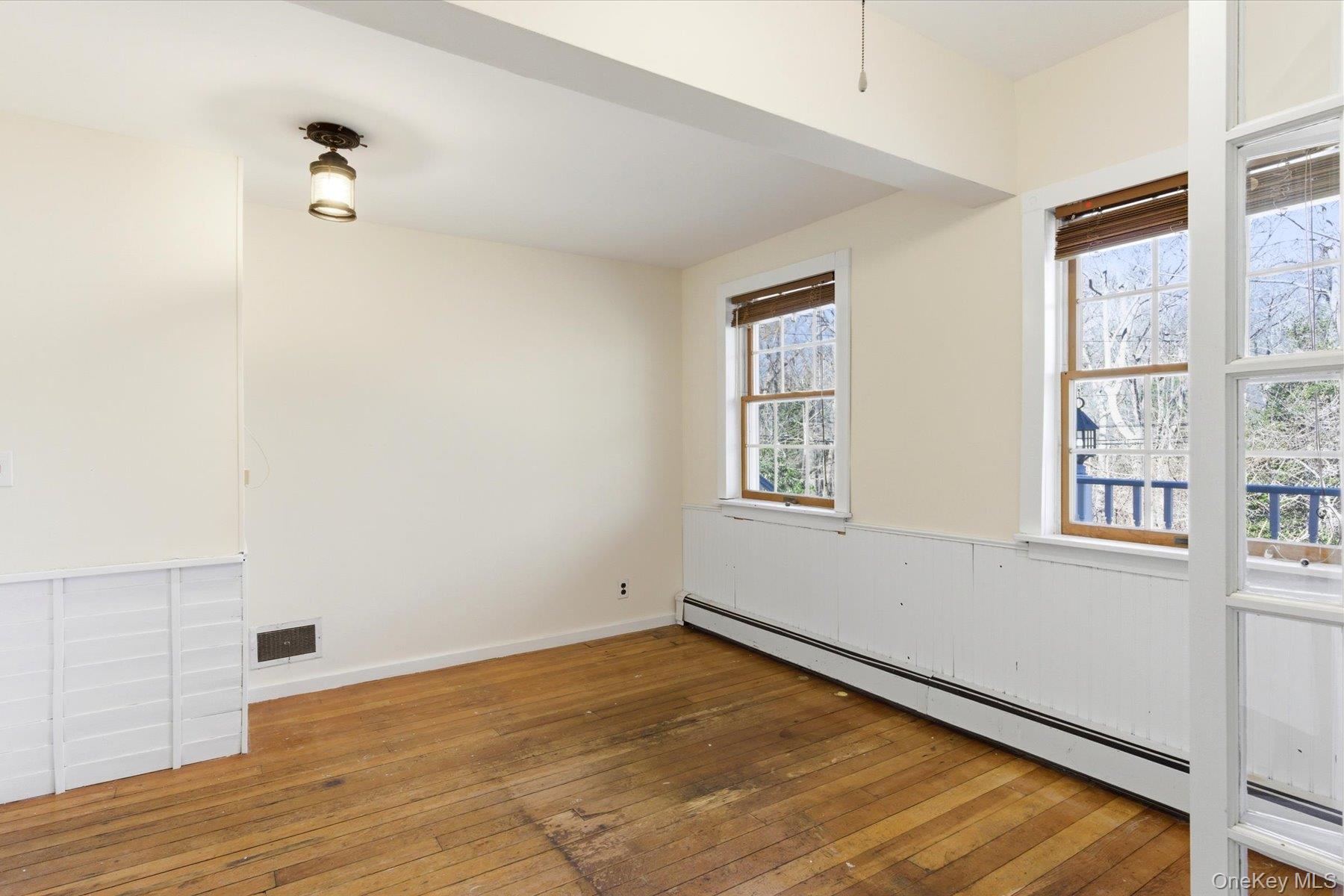 45 Eastwood Road Miller Place, NY 11764 - Photo 21 of 45 an empty room with wooden floor and windows