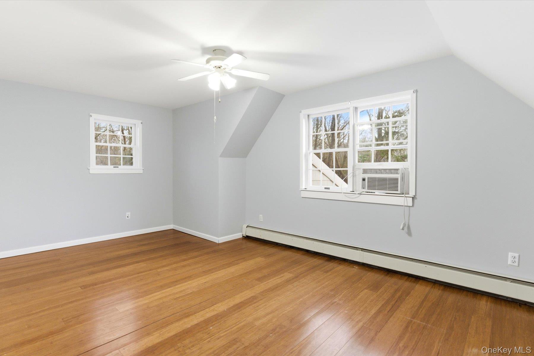 45 Eastwood Road Miller Place, NY 11764 - Photo 24 of 45 a view of an empty room with wooden floor and a window