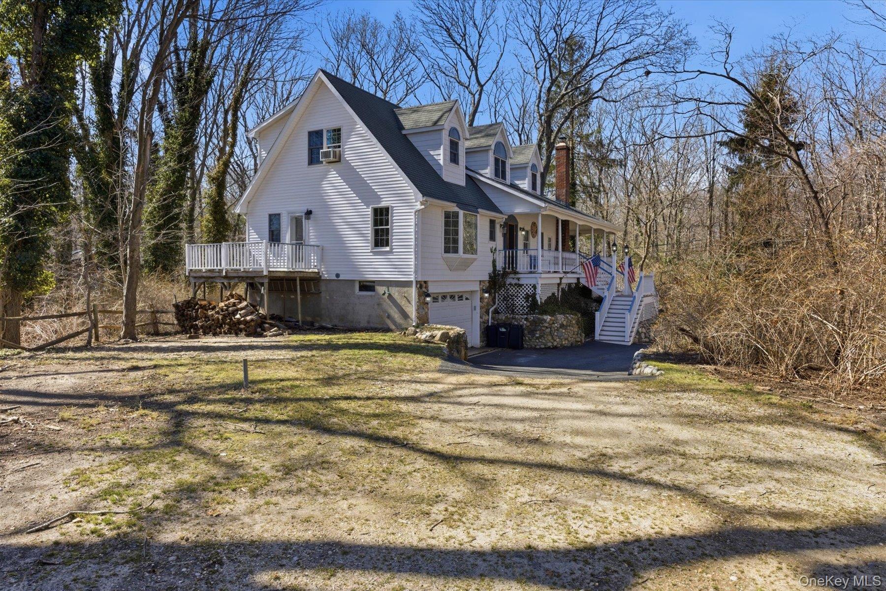 45 Eastwood Road Miller Place, NY 11764 - Photo 34 of 45 a view of a white house with a yard covered with snow