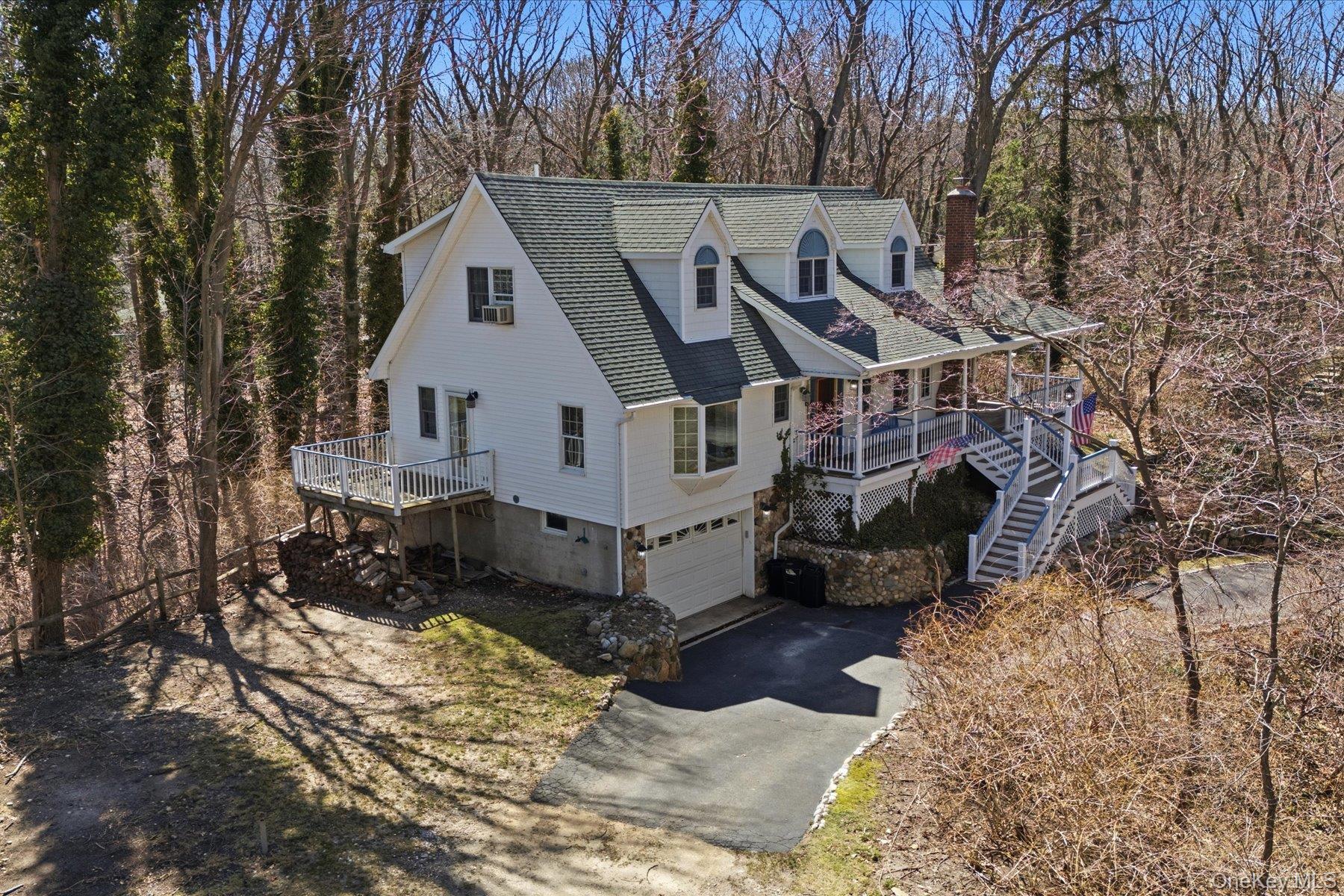 45 Eastwood Road Miller Place, NY 11764 - Photo 4 of 45 a front view of a house with a yard covered in snow